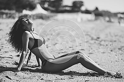 Arabic woman with beautiful body in bikini lying on the beach sa Stock Photo