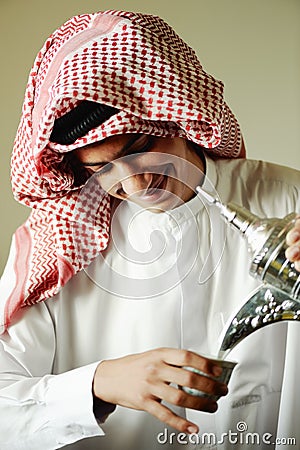 Arabic young man pouring a coffee Stock Photo