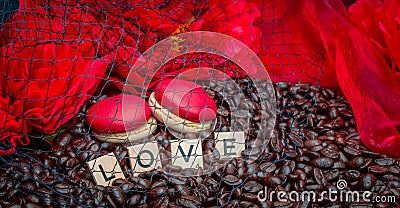 Red macaroon on rosted coffee beans sexy background with red flowers and letters LOVE Stock Photo