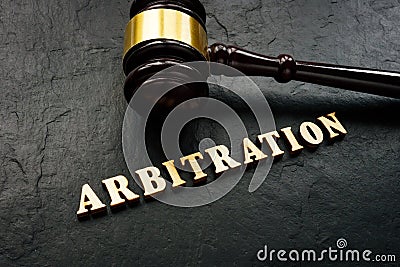 Arbitration word from wooden letters and gavel in court. Stock Photo