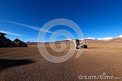 Arbol de Piedra rock or stone tree in the Siloli Desert. Snow-capped volcanoes and desert landscapes in the highlands of Bolivia Stock Photo