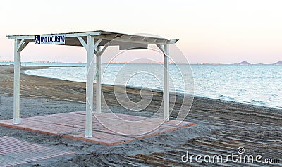 Arbor for Wheelchair user exclusive use at Los Narejos beach in Spain. Places in the Beach for people with disabilitiesthe sign is Stock Photo