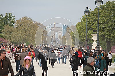 Crowded walking path in the park and in the background the Triumph Arc in Paris, France Editorial Stock Photo