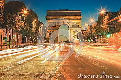 Arc De Triomphe and light trails at twilight, Paris Editorial Stock Photo