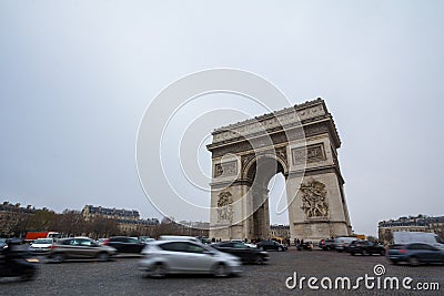 Arc de Triomphe triumph Arch on place de l`Etoile with a traffic jam of cars in front. Editorial Stock Photo