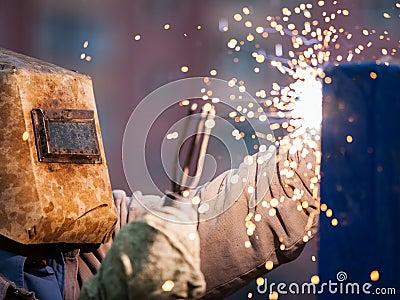 Arc welder worker in protective mask welding metal construction Stock Photo