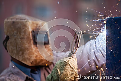 Arc welder worker in protective mask welding metal construction Stock Photo