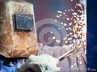 Arc welder worker in protective mask welding metal construction Stock Photo