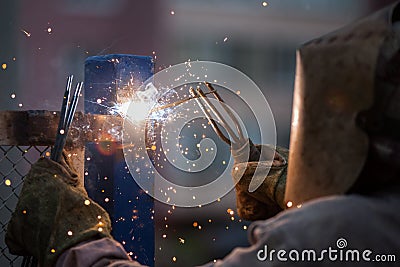 Arc welder worker in protective mask welding metal construction Stock Photo