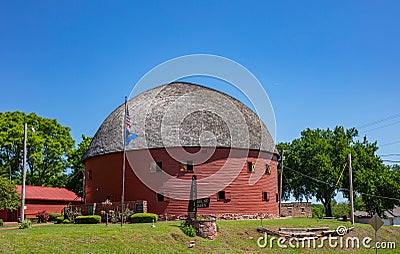 Arcadia round barn with red oak boards and grey roof, is a landmark next to route 66. Arcadia, Oklahoma, US Editorial Stock Photo