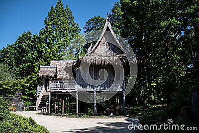 Arcen, The Netherlands - 28.5.2020 - Traditional asian stilt house in the castle park Kasteeltuinen Editorial Stock Photo