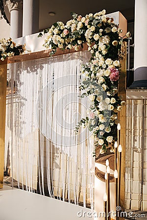 Arch decorated with flowers at the wedding caremony. White and gold color. Rose Stock Photo