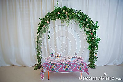 flower arch with flowers, branches and green leaves . Beautiful wedding ceremony design decoration elements with floral Editorial Stock Photo