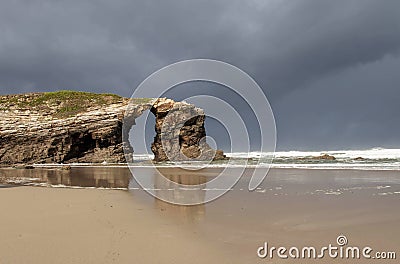 Arch hole in the rock formation at the beach of the Cathedrals Stock Photo