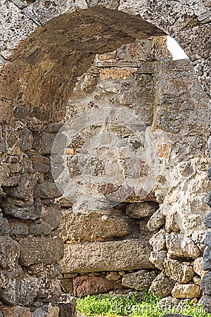 Arch lined stone limestone brown gray weathered broken ruins part of the old castle background design historic Stock Photo