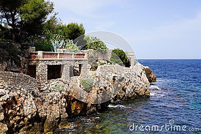 Arch passage private property on stone paved path along the coast Juan-les-Pins in Antibes France Stock Photo