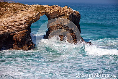 Arch in the rock. Beach Playa de Augas Santas Stock Photo