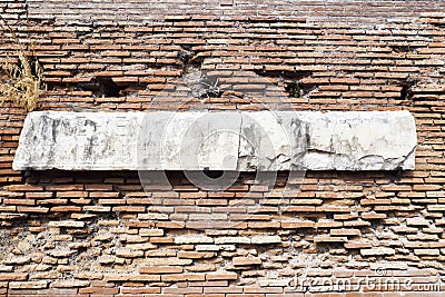 Archaeological excavations in Ostia Antica: Roman wall with marble engraved with Latin letters. Stock Photo