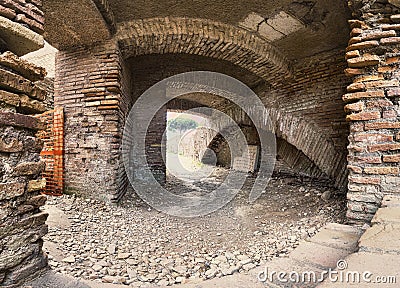 Archaeological excavations street view of ancient Roman ruin with vaults and pathways surrounded by brick walls Stock Photo