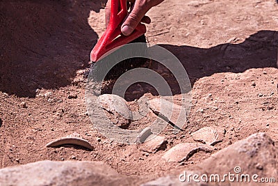 Archaeologist working on site, hand with brush Stock Photo
