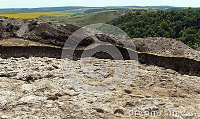 Archaeologists dug on a hole on hillside to search for historical artifacts and finds Stock Photo