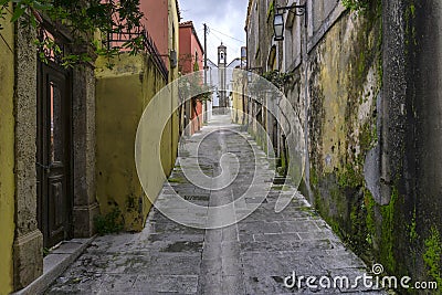 Narrow paved alley, in Archanes village that leads to a church, with old traditional houses Stock Photo