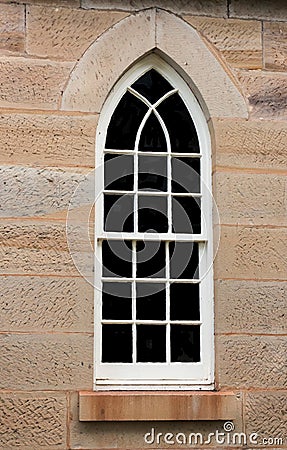 Arched church window set in sandstone bricks Stock Photo