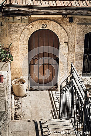 The arched door with metal lattice in Jerusalem, Israel Editorial Stock Photo