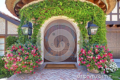 Arched double doors in a house with vines on the wall at La Jolla, California Stock Photo