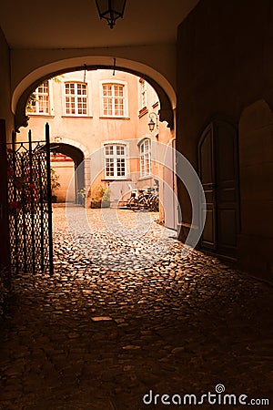 Arched entrance to courtyard on old European building Stock Photo