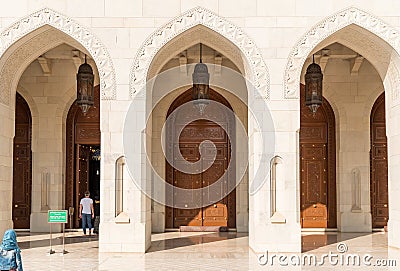 Arched gates and carved wooden doors leading to the Sultan Qaboos Grand Mosque, Oman, Middle East Editorial Stock Photo