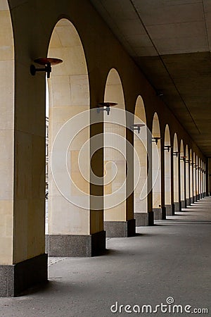 An arched passage near the building. Light passes through the arches. Stock Photo