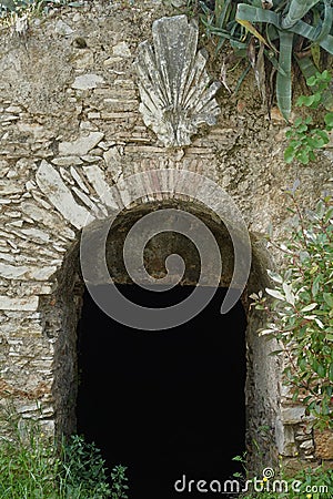 Arched stone gate of dark abandoned cellar Stock Photo