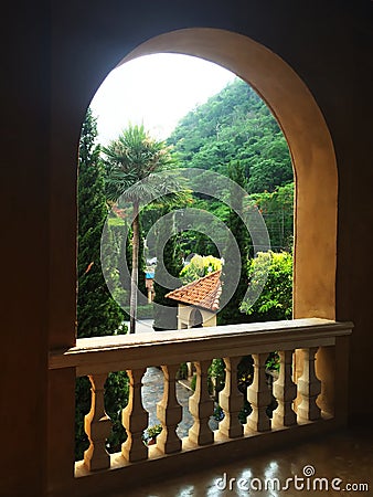 Arched Window frames made of concrete, Window open-air frame curve with a balcony railing to watch the view Stock Photo