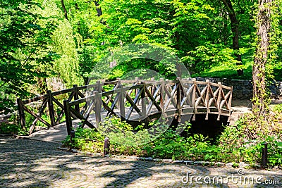 Arched wooden bridge in Sofiyivka park in Uman, Ukraine Stock Photo