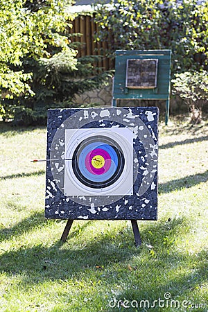 Used target for archery with an arrow in a bullseye on the train Stock Photo