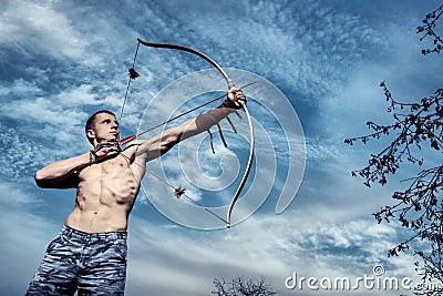 Archery. Young archer training with the bow Stock Photo