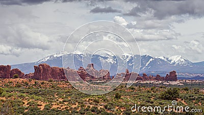 Arches panorama and snowcapped mountains in the background Stock Photo