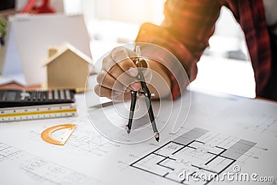 Architect Asian man drafting blueprint at table in office Stock Photo