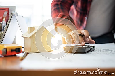 Architect Asian man drafting blueprint at table in office Stock Photo