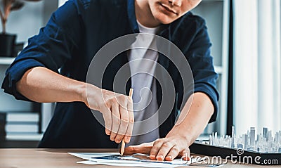 Architect or city planner draws city plan on blueprint. Iteration Stock Photo