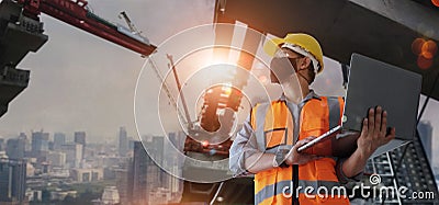 Architect, civil engineer holding laptop inspect and oversee infrastructure progress and security of city construction project. Stock Photo
