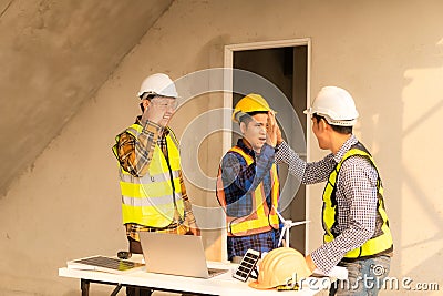 Architect and construction engineer holding hands while working for teamwork and cooperation concept after completing Stock Photo