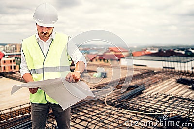 architect on construction site with plans and hardhat. vintage filter edit Stock Photo