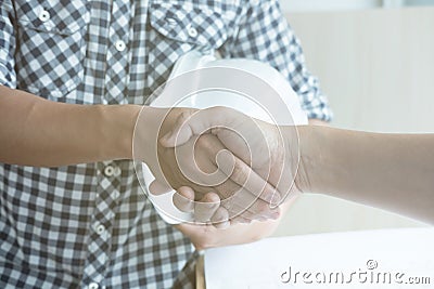 Architect and customer shaking hands at workplace. Engineer hand Stock Photo