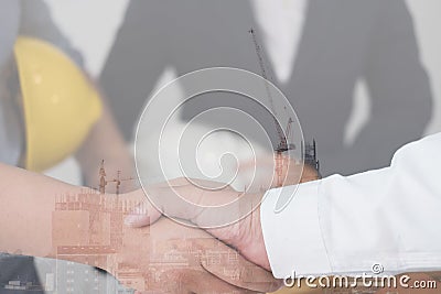 Architect & customer shaking hands. Engineer handshaking with pa Stock Photo