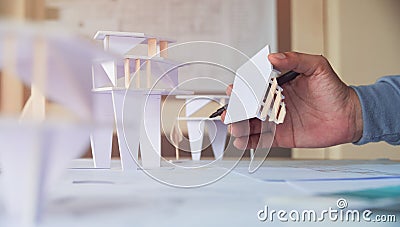 Architect design working drawing sketch plans blueprints and making architectural construction model in architect studio Stock Photo