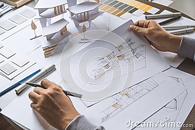 Architect design working drawing sketch plans blueprints and making architectural construction model in architect studio Stock Photo