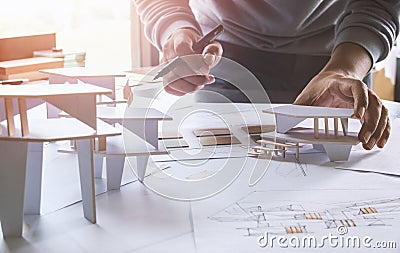 Architect design working drawing sketch plans blueprints and making architectural construction model in architect studio Stock Photo