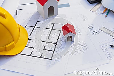 Architect desk with blueprint and hard hat constuction building Stock Photo